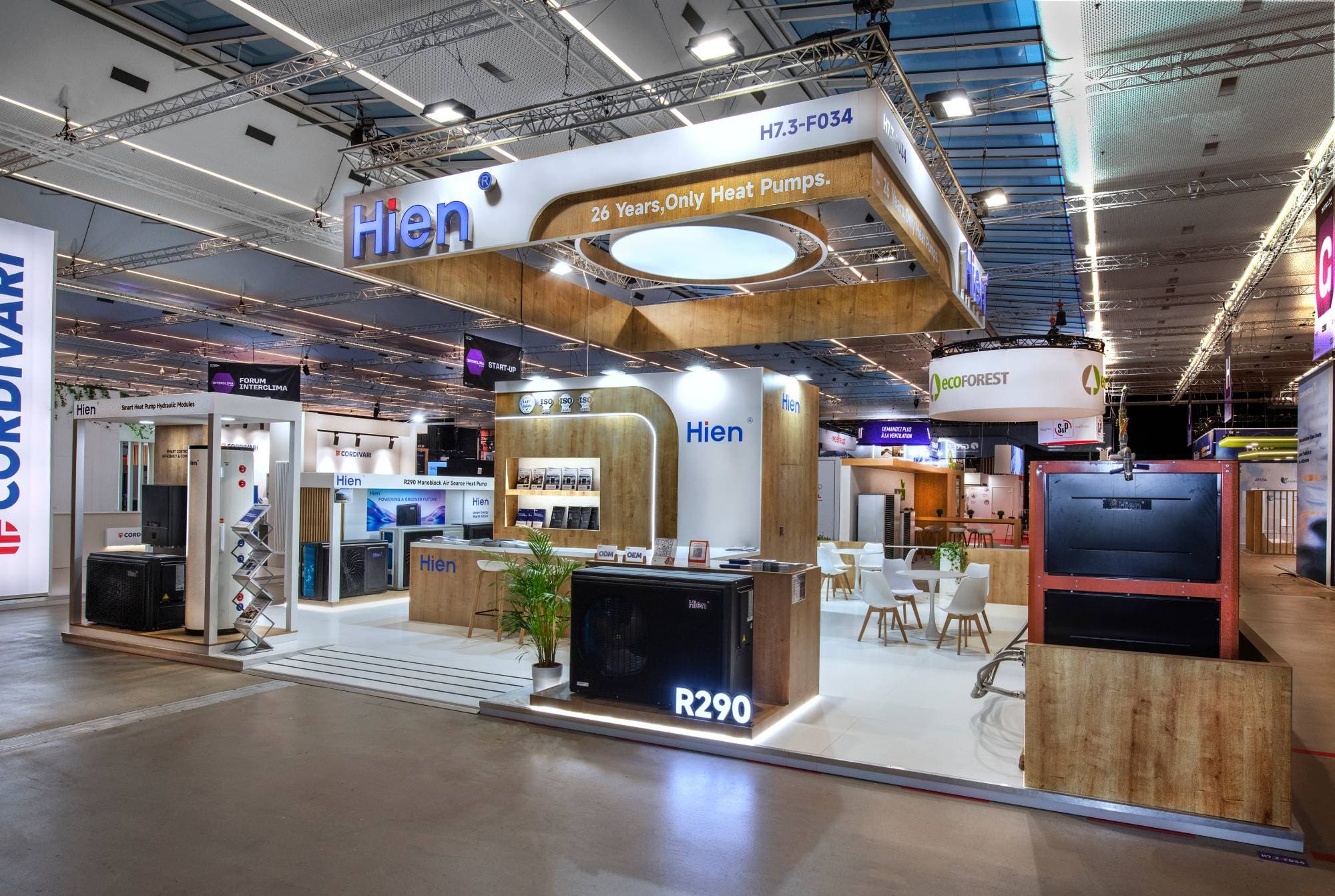 Hien stand at Batimat: suspended structure with illuminated sign and ring of light, wood cladding, spotlit R290 unit